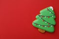 Christmas tree shaped gingerbread cookie on red, top view. Space for text Royalty Free Stock Photo