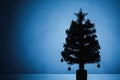 Christmas tree silhouette, blue background