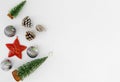 Christmas tree, silver balls, red star and pine cone on white background. Royalty Free Stock Photo