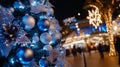 Christmas tree with silver and blue ornaments, blurred winter carnival Royalty Free Stock Photo