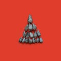 Christmas tree of silver fir cones on a red background