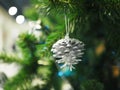 A Christmas tree with silver pine core ornaments is a festive sight. Selective focus. Royalty Free Stock Photo