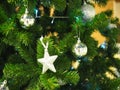 A Christmas tree with silver star and ball ornaments is a festive sight. Selective focus. Royalty Free Stock Photo