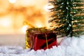 Christmas tree on snow with gift and light bokeh backgrounds ,Snowy Christmas or New Year festive background Royalty Free Stock Photo