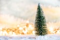 Christmas tree on snow with gift and light bokeh backgrounds ,Snowy Christmas or New Year festive background Royalty Free Stock Photo