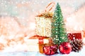 Christmas tree on snow with gift and light bokeh backgrounds ,Snowy Christmas or New Year festive background Royalty Free Stock Photo