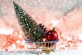 Christmas tree on snow with gift and light bokeh backgrounds ,Snowy Christmas or New Year festive background Royalty Free Stock Photo