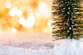 Christmas tree on snow with gift and light bokeh backgrounds ,Snowy Christmas or New Year festive background Royalty Free Stock Photo