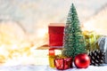 Christmas tree on snow with gift and light bokeh backgrounds ,Snowy Christmas or New Year festive background Royalty Free Stock Photo