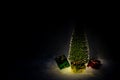 Christmas tree on snow with gift and light bokeh backgrounds ,Snowy Christmas or New Year festive background Royalty Free Stock Photo