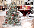 Christmas tree  on snowy street red lantern and candle glas  on wooden table in Tallinn Old Town medieval city holiday decoration Royalty Free Stock Photo