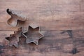 Christmas tree, star, and deer shaped cookie cutters on a wooden table. Christmas background. Royalty Free Stock Photo