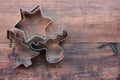 Christmas tree, star, and deer shaped cookie cutters on a wooden table. Christmas background. Royalty Free Stock Photo