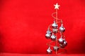 christmas tree with star and silver spheres on red textured velvet background Royalty Free Stock Photo