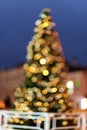 christmas tree on the street out of focus. bokeh festive garlands.