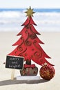 Christmas tree and text merry and bright on the beach Royalty Free Stock Photo