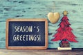 Christmas tree and text seasons greetings in a chalkboard Royalty Free Stock Photo