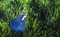 Christmas tree toy on the background of artificial green grass