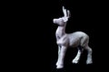 Christmas tree toy, shining silver deer standing on a black background, close-up. little Santa helper decoration Royalty Free Stock Photo