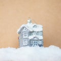 Christmas tree toy silver house on a snowdrift on a craft background. Royalty Free Stock Photo