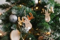 Christmas tree toy wooden elk hanging on a christmas tree with lights Royalty Free Stock Photo