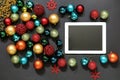 Christmas tree toys balls and ipad on dark background. Royalty Free Stock Photo