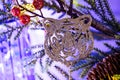 Christmas tree toys close-up. A silver tiger`s muzzle hangs on a branch of a decorative Christmas tree. Royalty Free Stock Photo