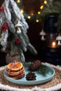 A Christmas tree with toys and a plate with red viburnum berries and orange slices.