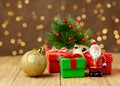 christmas tree toys santa claus with gifts on a blurry background with bokeh Royalty Free Stock Photo