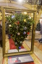 A Christmas tree turned upside down and set in a picture frame as a piece of a contemporary art