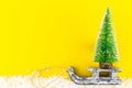 Christmas tree and vintage wooden sled over trendy background Royalty Free Stock Photo