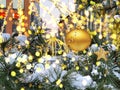 City Festive  Christmas ball  snowypine  tree branch and cone with garland light blurred  light  in winter holiday  decoration Royalty Free Stock Photo