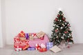 Christmas tree in a white room with Christmas decorations and gifts toys Royalty Free Stock Photo