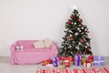 Christmas tree in a white room with Christmas decorations and gifts toys Royalty Free Stock Photo