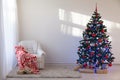 Christmas tree in a white room for Christmas with gifts