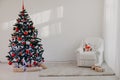 Christmas tree in a white room for Christmas with gifts