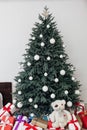 Christmas tree in the white room decor pine for the new year with postcard gifts