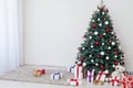 Christmas tree in the white room decor pine for the new year with postcard gifts