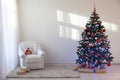 Christmas tree in a white room for Christmas with gifts Royalty Free Stock Photo