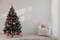 Christmas tree in a white room for Christmas with gifts