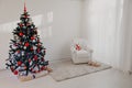 Christmas tree in a white room for Christmas with gifts