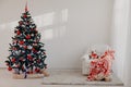 Christmas tree in a white room for Christmas with gifts Royalty Free Stock Photo