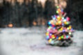 Christmas tree in winter forest with colored lights Royalty Free Stock Photo