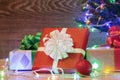 Christmas tree on a wooden background with a garland and gifts