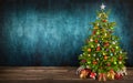 Christmas tree on wooden floor with teal background