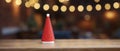 Christmas tree on wooden table in front of blurred background with bokeh Royalty Free Stock Photo
