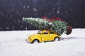 Christmas tree on yellow toy car with snow, Merry Christmas conc Royalty Free Stock Photo