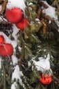 Christmas trees decorated with red balloons in front of the cafe entrance. Street Christmas decorations.