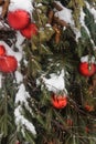 Christmas trees decorated with red balloons in front of the cafe entrance. Street Christmas decorations.