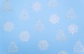 Christmas trees and snowflakes on a sky-blue background. The view from the top Royalty Free Stock Photo